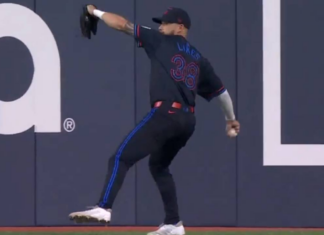 Blue Jays’ Lukes fires a throw to get Rangers’ Carter out at second