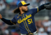 Peralta earns MLB-best 15th win as Brewers blank Cubs
