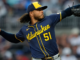 Peralta earns MLB-best 15th win as Brewers blank Cubs