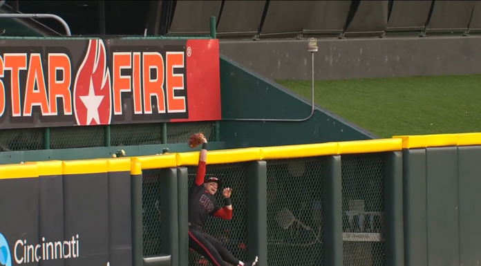 Reds’ Friedl gets up over the fence for home-run robbery